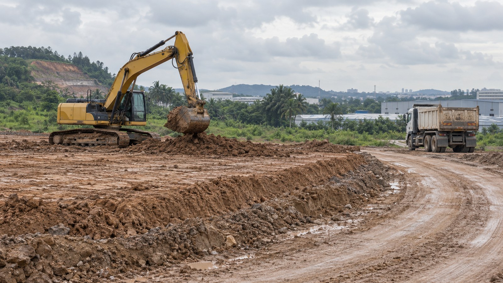 Illustrative excavator and tipper truck on separate working and haulage areas at a Malaysian earthworks site